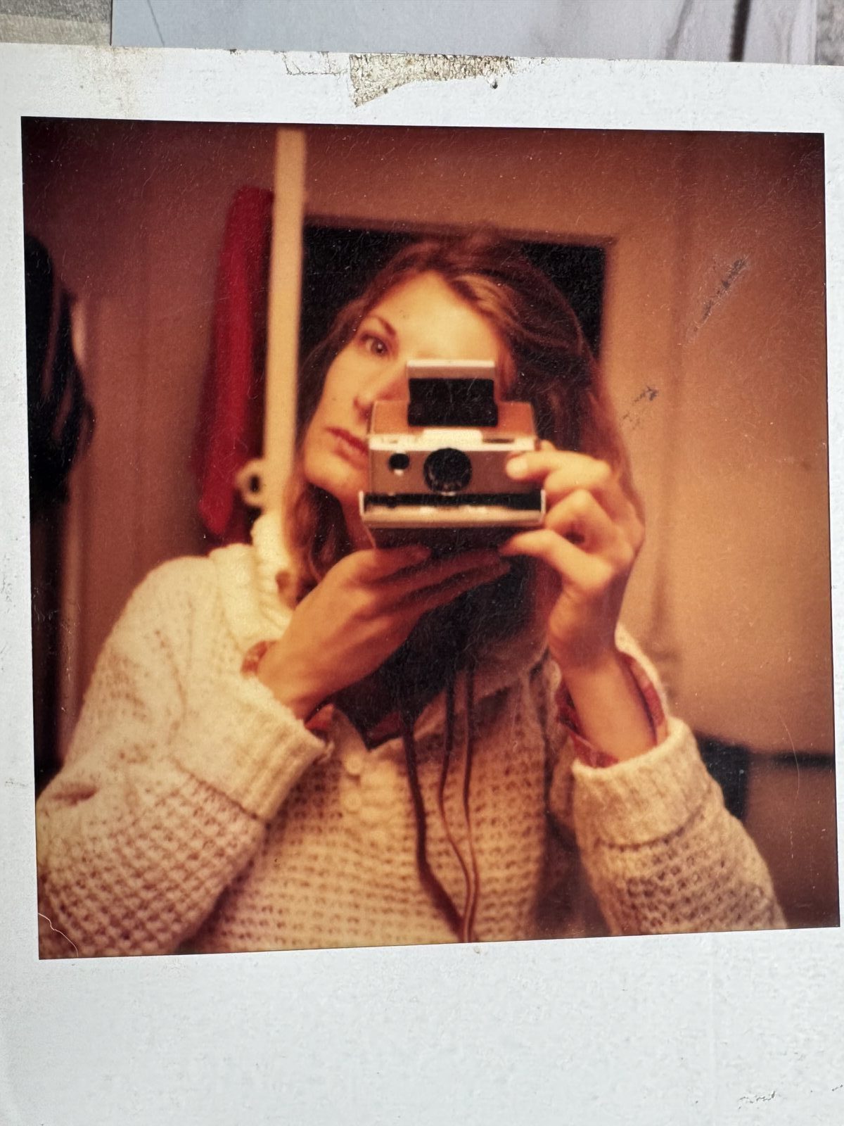 Polaroid self-portrait with camera